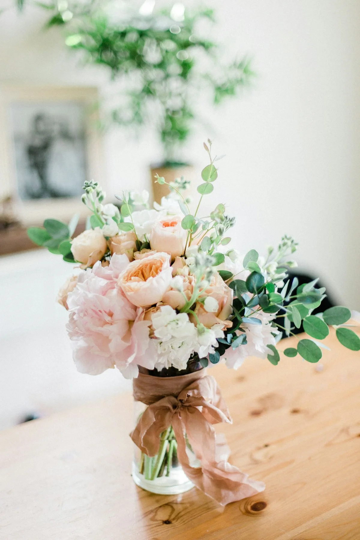 Bouquet of pale pink and white flowers with eucalyptus foliage