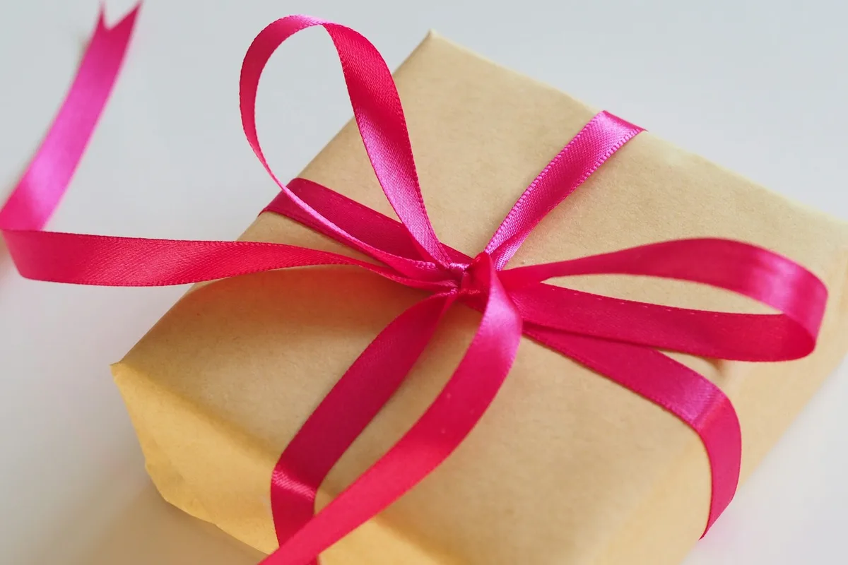 A wrapped gift with a bright pink ribbon