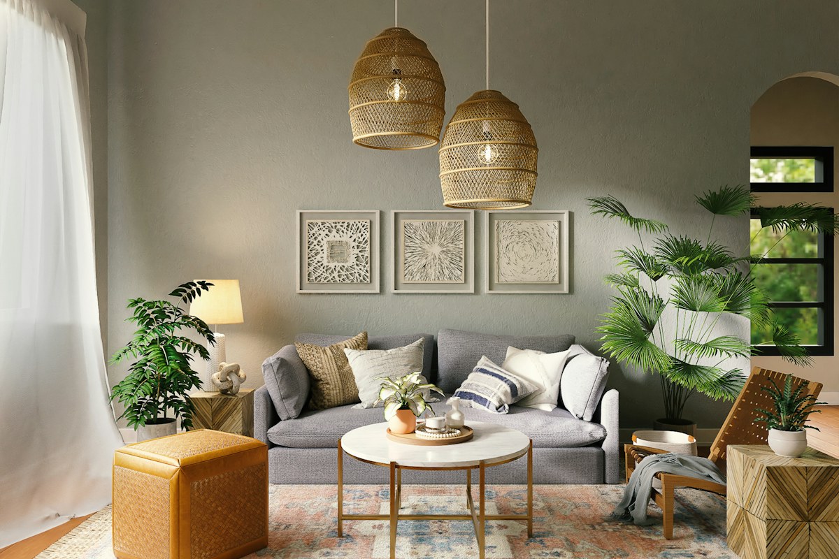 Grey sofa with patterned cushions beneath woven pendant lights