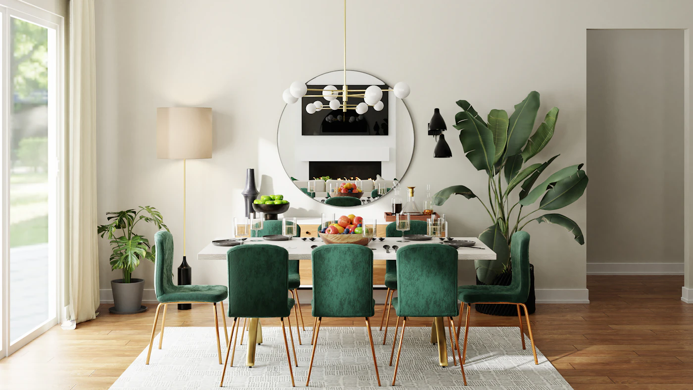 Dining table with green chairs, indoor plants and a round wall mirror